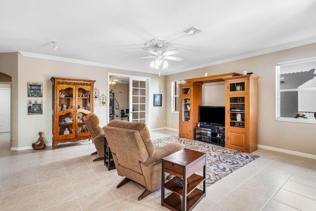 living room with a ceiling fan, arched walkways, baseboards, and visible vents