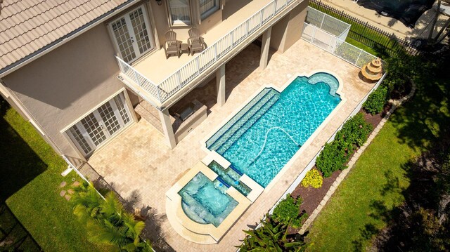 community pool featuring fence, a patio, and french doors