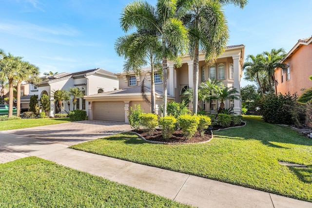 view of front of property with a tiled roof, decorative driveway, a garage, a front lawn, and stucco siding