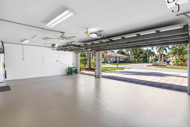 garage with water heater and a garage door opener