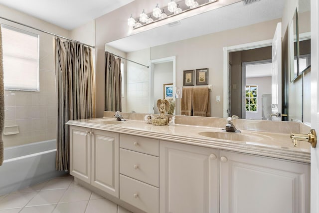 full bath with tile patterned floors, a sink, and a healthy amount of sunlight