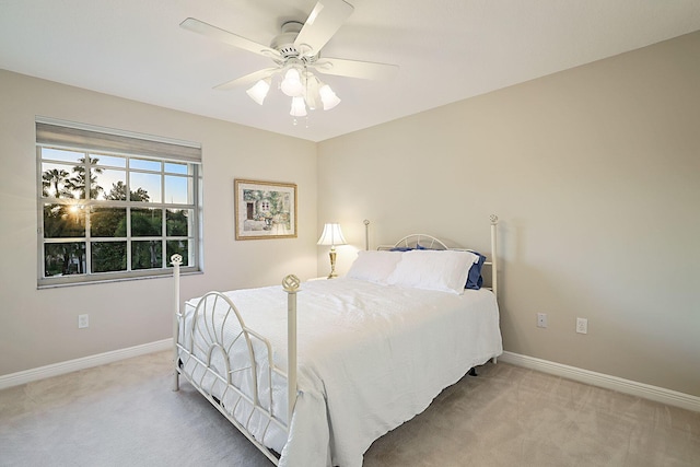 bedroom with baseboards, carpet flooring, and a ceiling fan