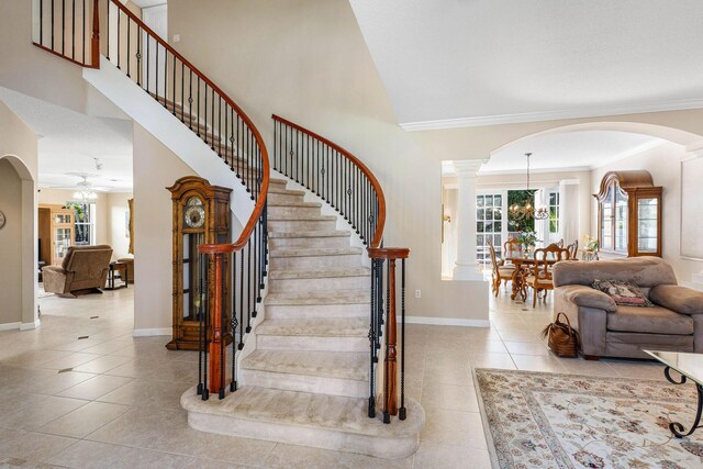 dining space featuring visible vents, stairway, crown molding, a notable chandelier, and light tile patterned flooring