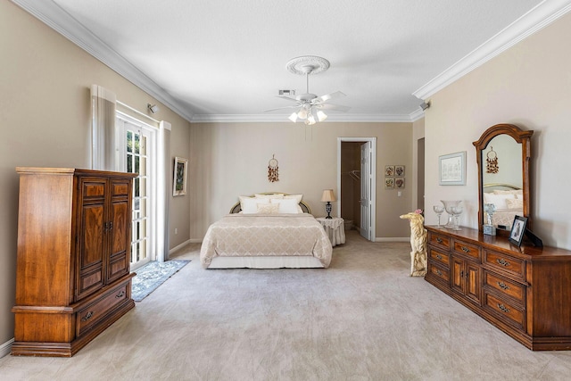 bedroom with ornamental molding, light carpet, and baseboards