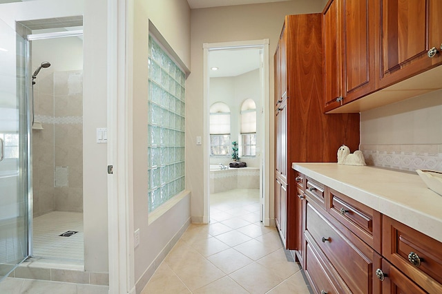 interior space featuring light tile patterned flooring, brown cabinets, light countertops, and baseboards