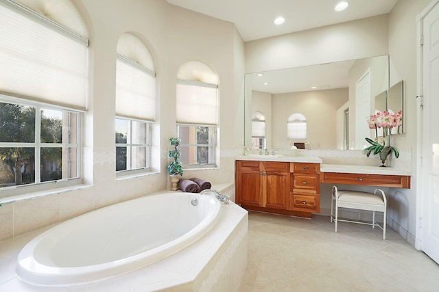 full bathroom with tile patterned floors, vanity, a garden tub, and recessed lighting