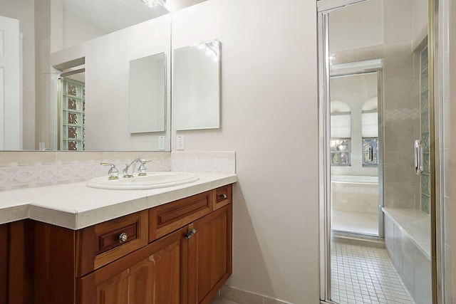 bathroom with a stall shower, tile patterned flooring, and vanity