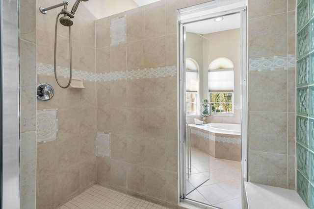 full bathroom featuring a stall shower, tile patterned floors, and a garden tub