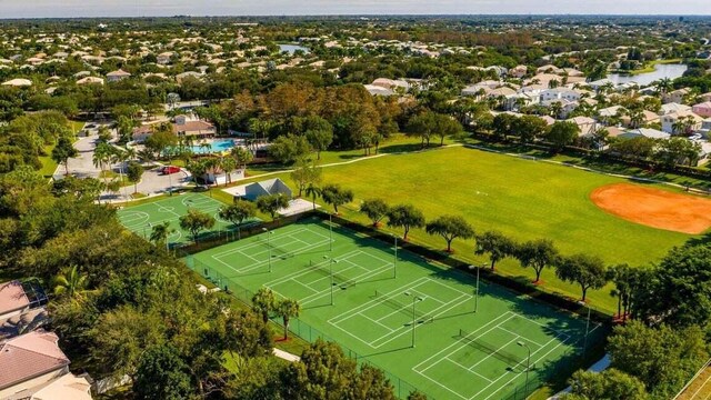 view of sport court with community basketball court, a yard, and fence