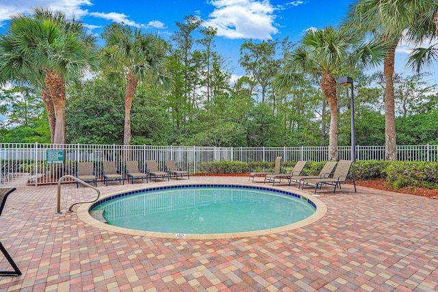 view of pool with a patio area, fence, and a fenced in pool