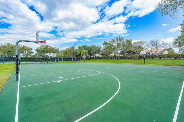 view of basketball court with a yard and community basketball court