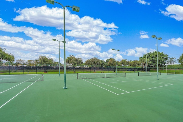 view of sport court featuring fence