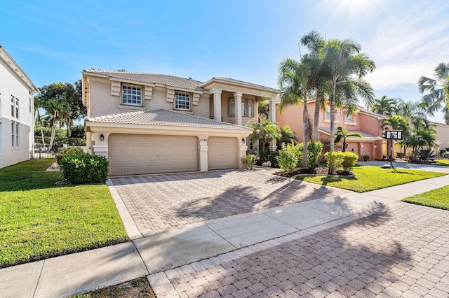 view of front of property with a front lawn, decorative driveway, stucco siding, and a tiled roof