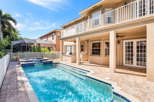 view of swimming pool featuring ceiling fan, a fenced backyard, french doors, and area for grilling