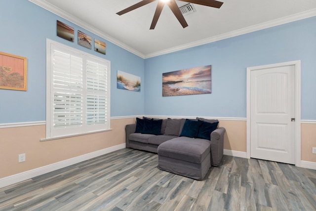 living area featuring hardwood / wood-style flooring, ceiling fan, and ornamental molding