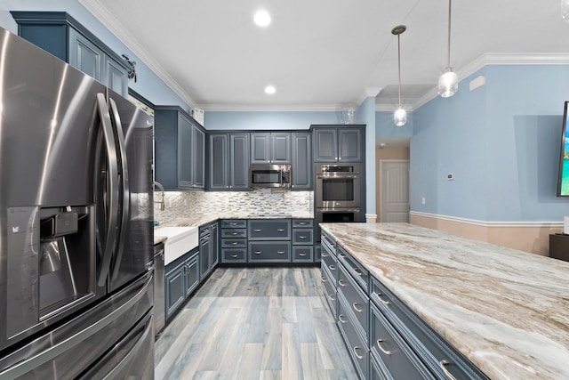 kitchen with light stone counters, backsplash, crown molding, pendant lighting, and appliances with stainless steel finishes