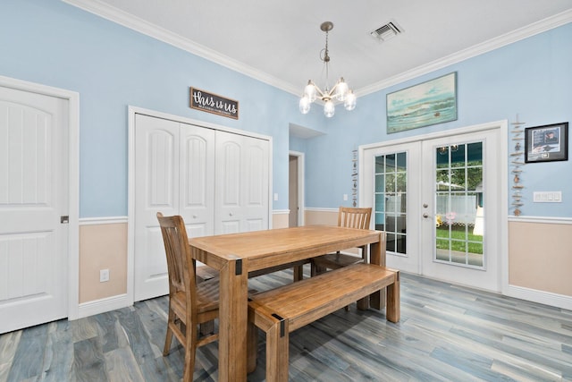 dining space featuring a chandelier, french doors, dark hardwood / wood-style floors, and crown molding