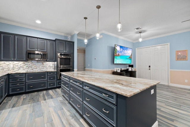 kitchen featuring crown molding, hanging light fixtures, stainless steel appliances, light stone counters, and a kitchen island