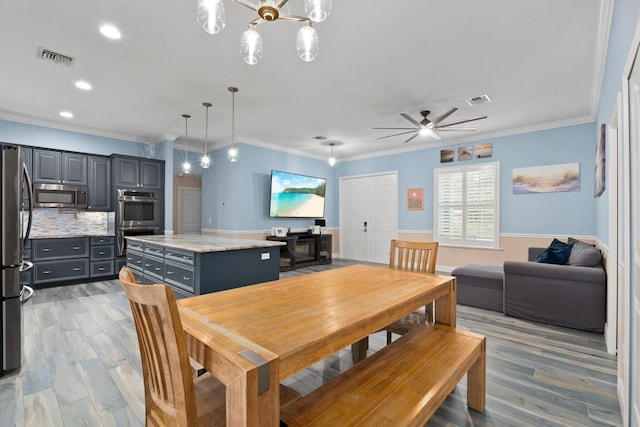 dining area with crown molding, light hardwood / wood-style flooring, and ceiling fan with notable chandelier