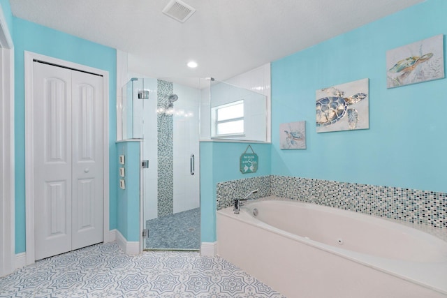 bathroom featuring tile patterned flooring, a textured ceiling, and shower with separate bathtub