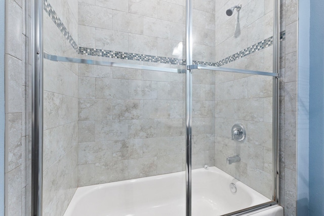 bathroom featuring shower / bath combination with glass door