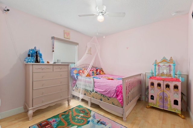 bedroom with ceiling fan and hardwood / wood-style floors