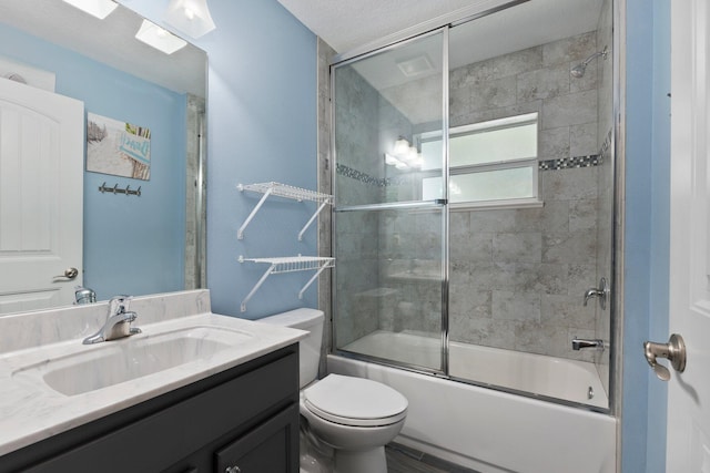 full bathroom with vanity, combined bath / shower with glass door, and toilet