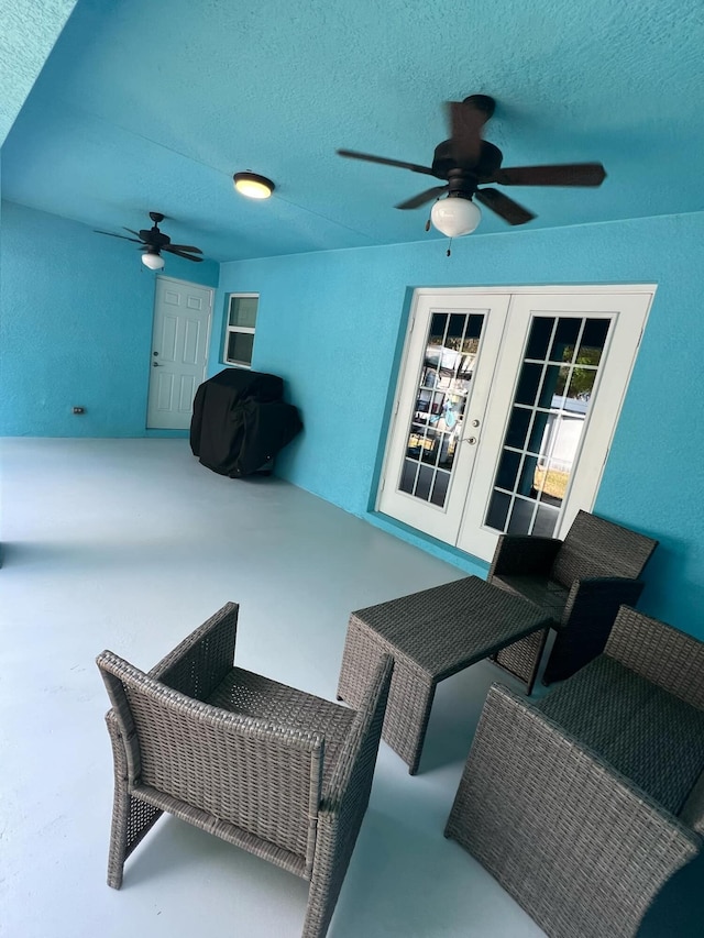 view of patio with french doors, ceiling fan, a grill, and an outdoor living space