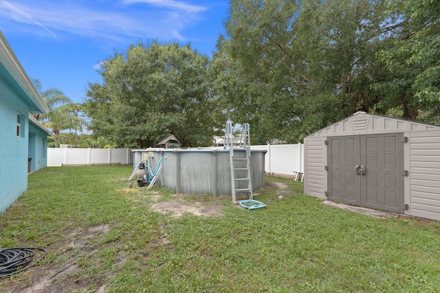 view of yard featuring a storage unit and a fenced in pool