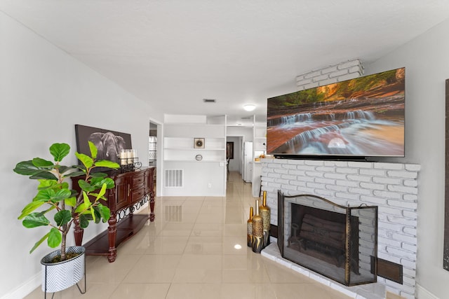 tiled living room with a brick fireplace