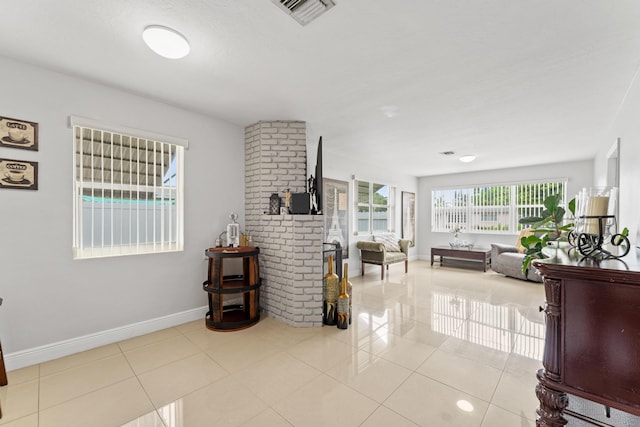 living room with brick wall and light tile patterned floors