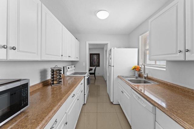 kitchen featuring white cabinets, sink, white appliances, and light tile patterned floors