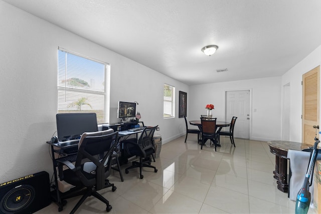 office space with tile patterned flooring and a wealth of natural light