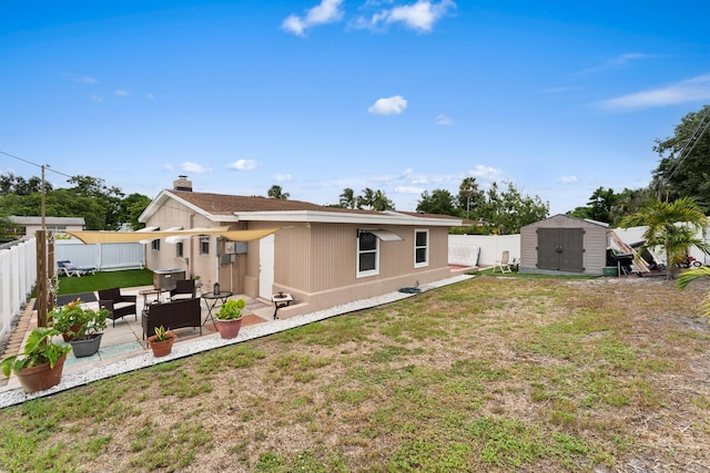 rear view of property with a patio area, a storage unit, an outdoor hangout area, and a lawn