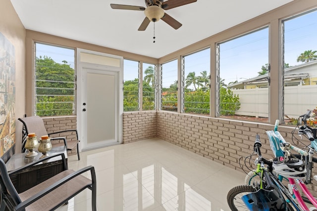 sunroom featuring a wealth of natural light and ceiling fan