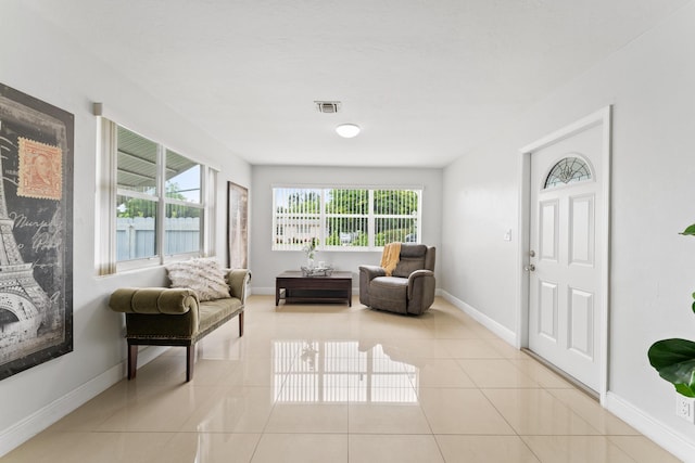 living area featuring a wealth of natural light and light tile patterned floors