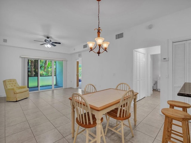 dining space featuring ceiling fan with notable chandelier and light tile patterned floors