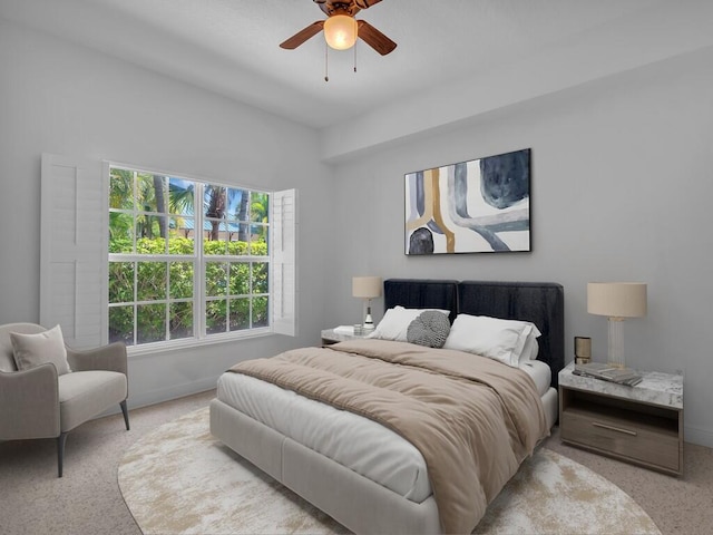 bedroom featuring light colored carpet, multiple windows, and ceiling fan