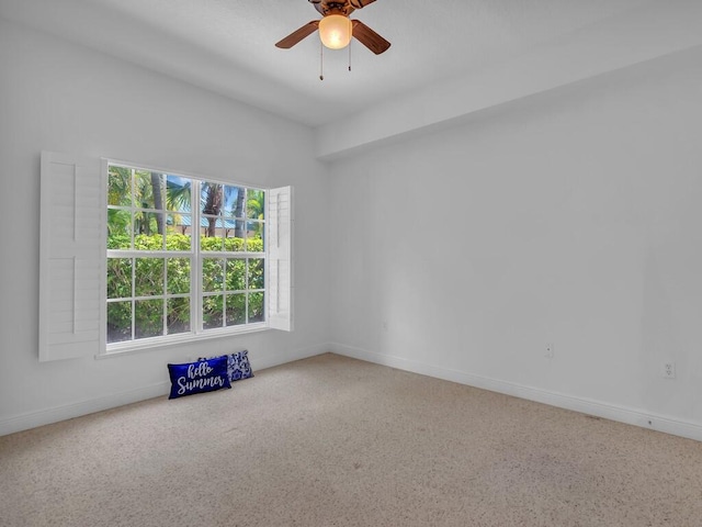 carpeted empty room featuring ceiling fan and a wealth of natural light