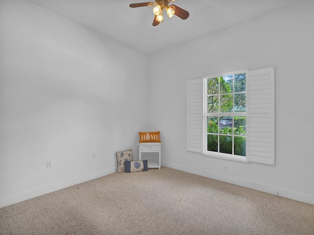 carpeted spare room with ceiling fan