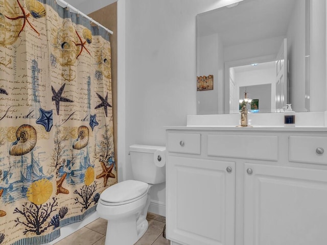 bathroom featuring vanity, toilet, and tile patterned flooring