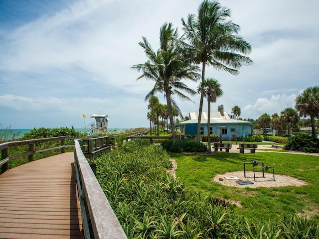 view of property's community with a water view and a yard