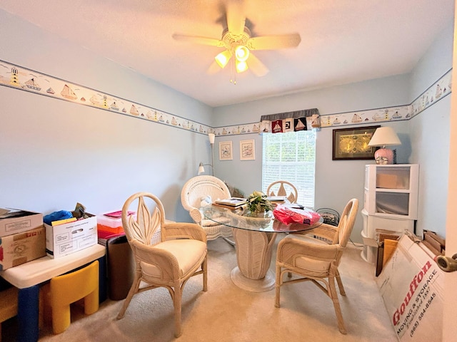 carpeted dining area featuring ceiling fan