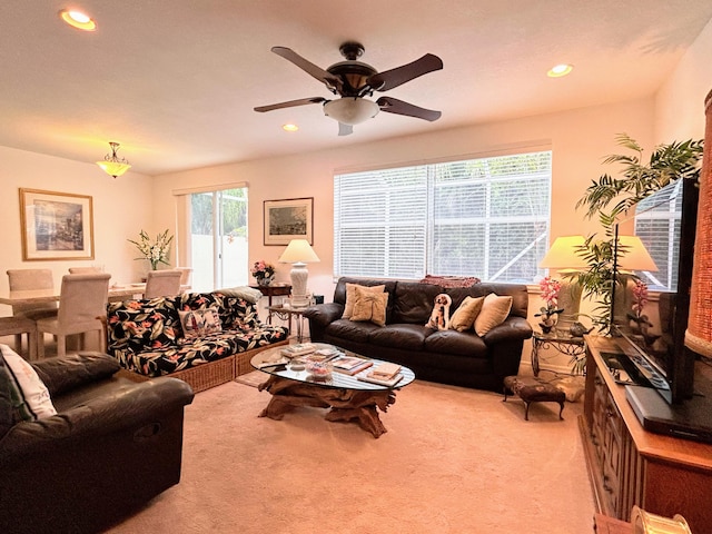 carpeted living room featuring ceiling fan