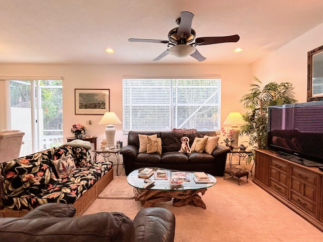 carpeted living room featuring ceiling fan