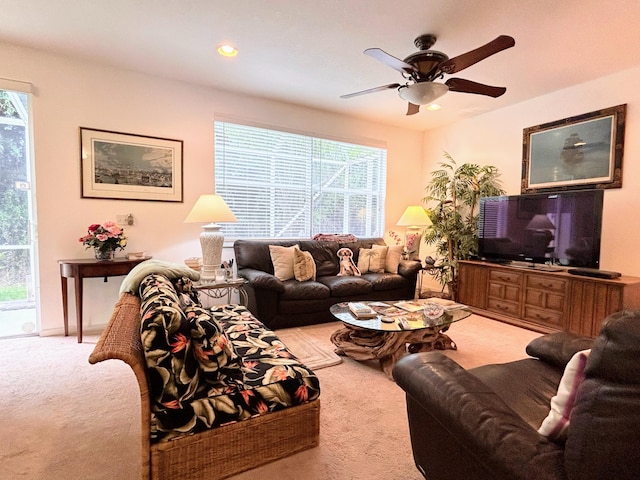 carpeted living room featuring ceiling fan