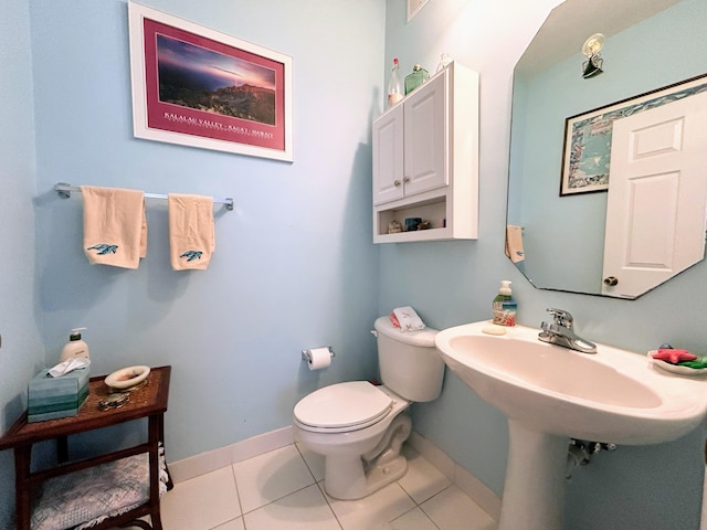 bathroom with toilet and tile patterned flooring