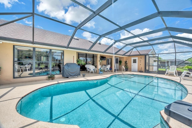 view of swimming pool featuring glass enclosure, a grill, and a patio