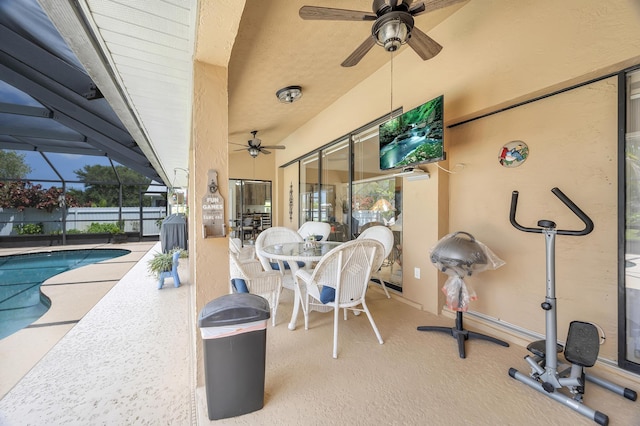 view of patio / terrace featuring a fenced in pool, a lanai, and ceiling fan