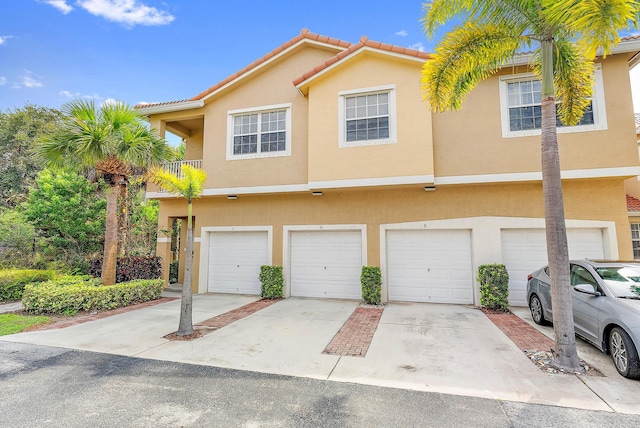 multi unit property with a garage and a balcony